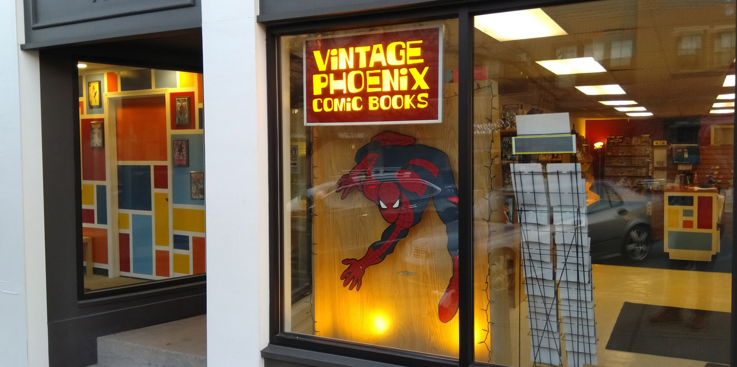 Photograph of Vintage Phoenix comics storefront with a spiderman cut-out.